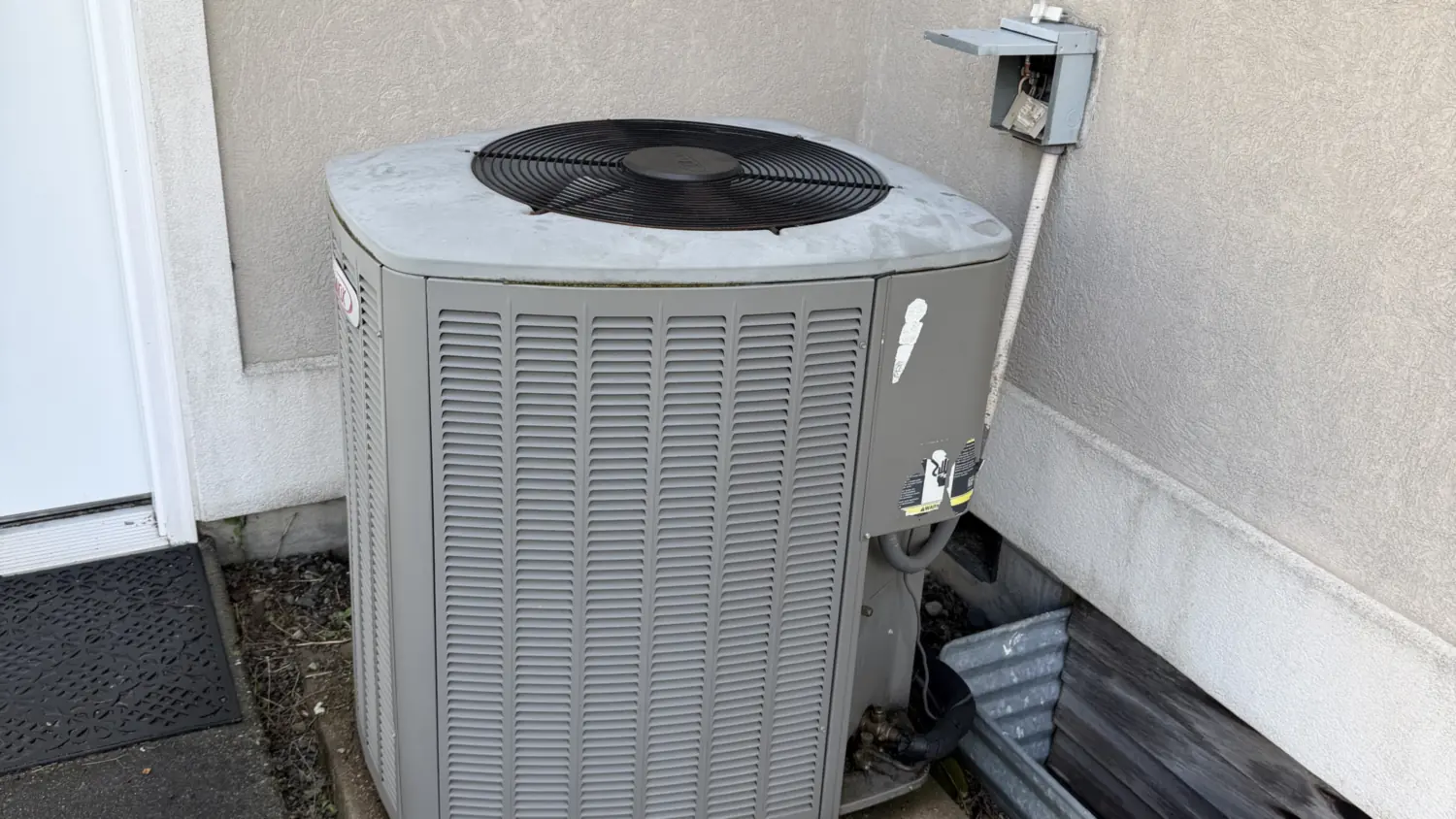Lennox air conditioning condenser on a concrete pad beside a Pierce County, WA home