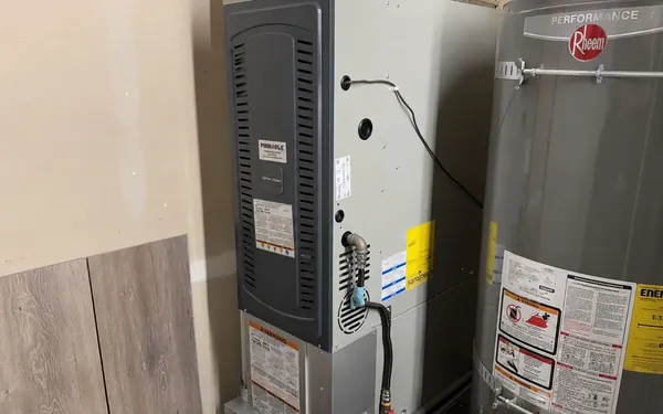Newly installed gas furnace beside a water heater in a Puyallup, WA garage