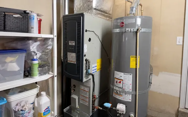 Furnace, air handler and water heater in a Pierce County, WA garage before a seasonal maintenance visit